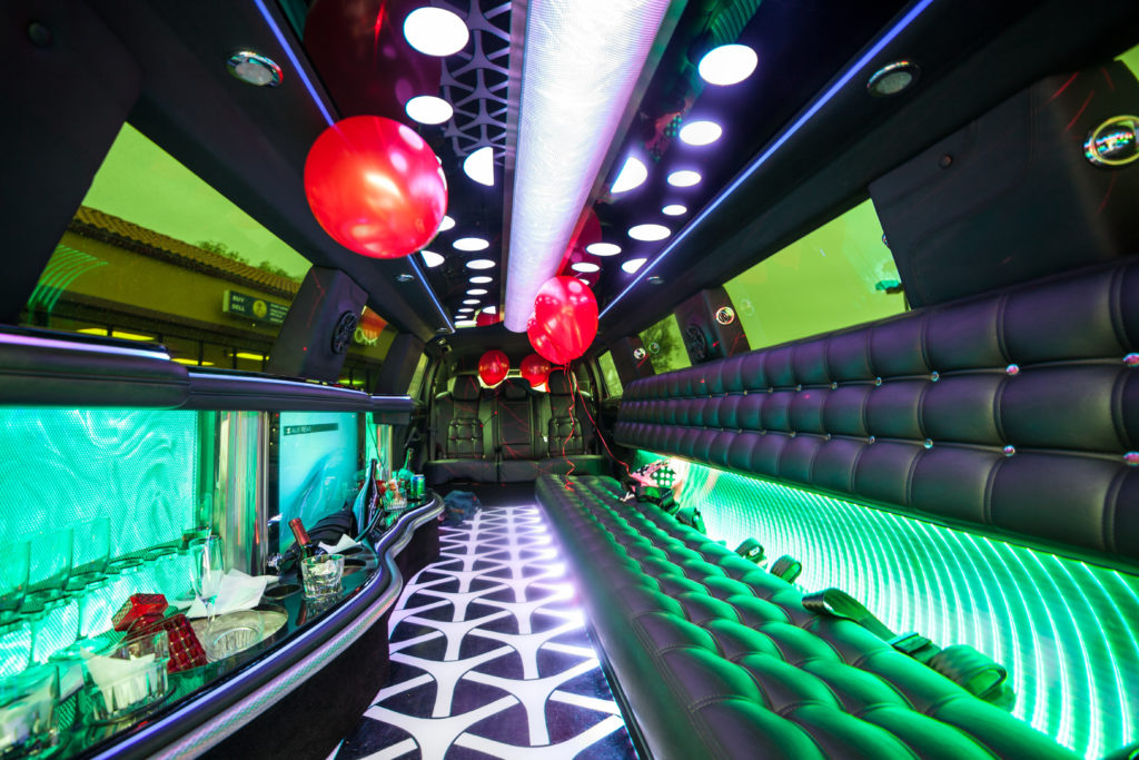 The inside of a party bus decorated with balloons